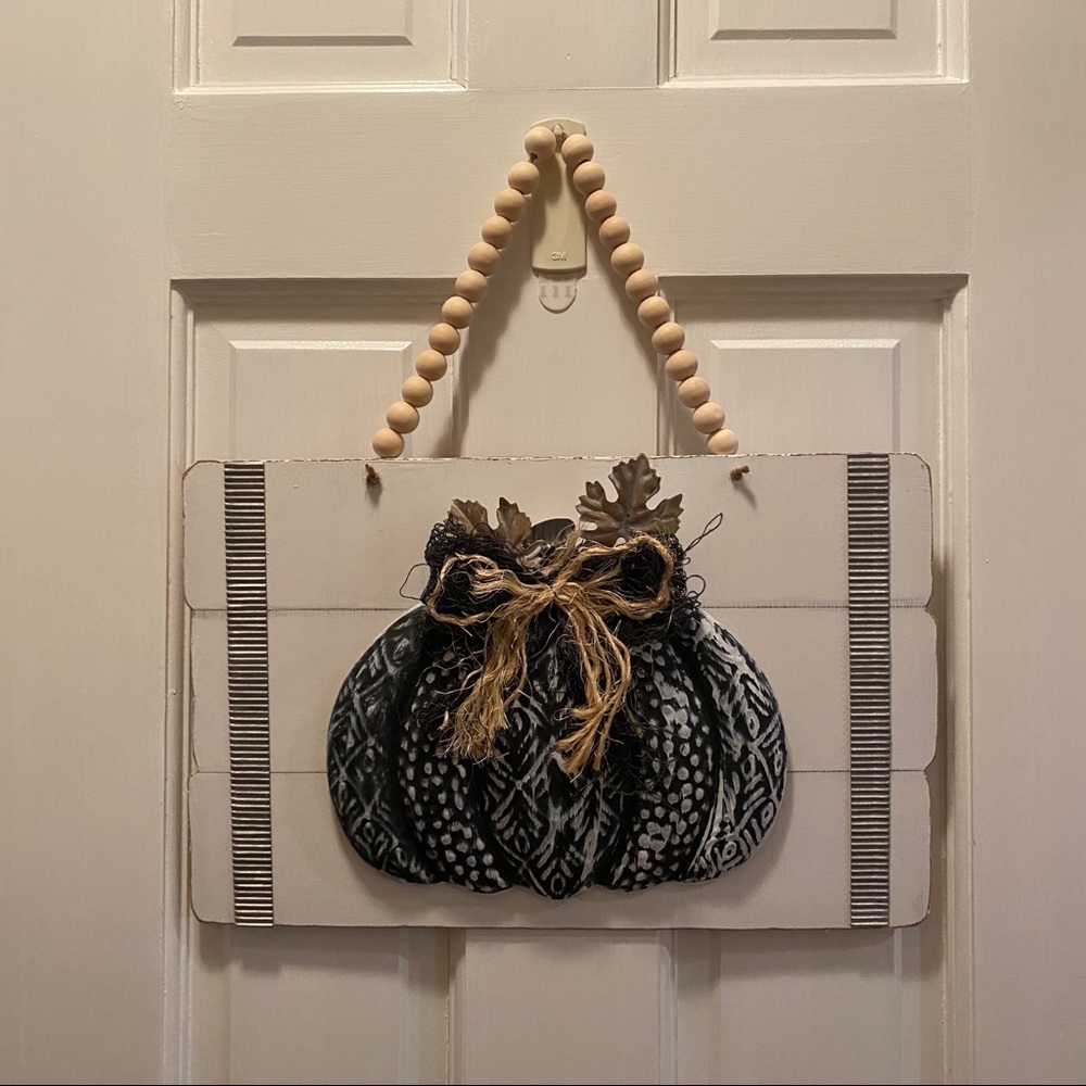 Black Metal Pumpkin on White Sign